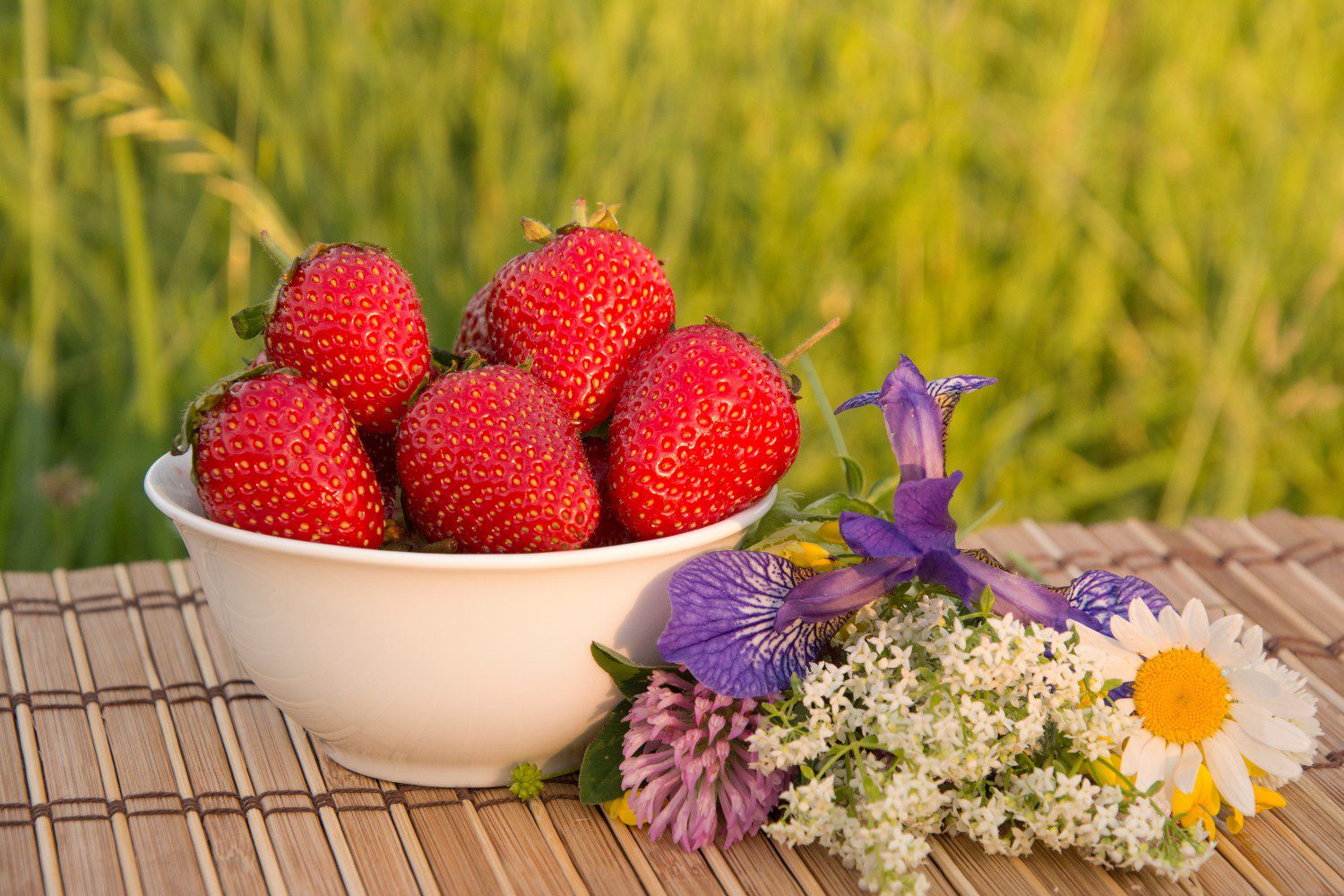 Fresh strawberries and garden flowers