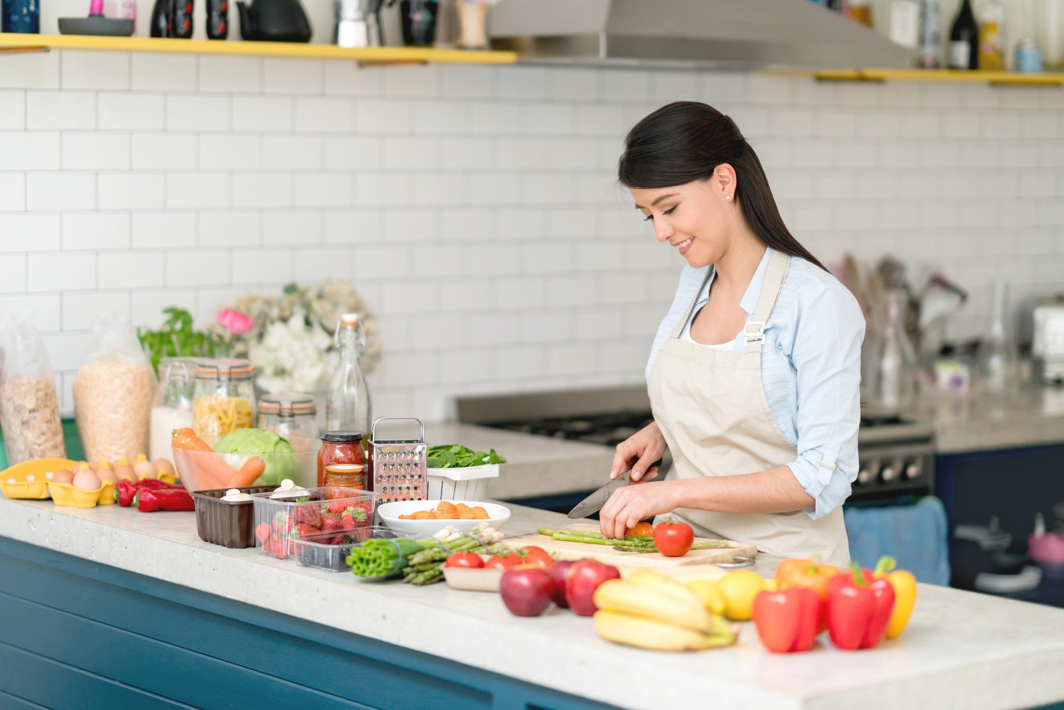 Cooking with fresh produce in kitchen